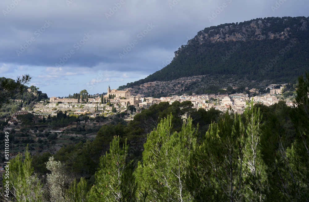 Balldemossa, beautiful view of this charming town, with its church of Sant Bartomeu and in the background the imposing Sierra de Tramuntana