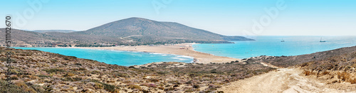Prasonisi beach with Aegean and Mediterranean seas on Rhodes. Isthmus sand beach divides turquoise water of seas against rocky hills under blue sky