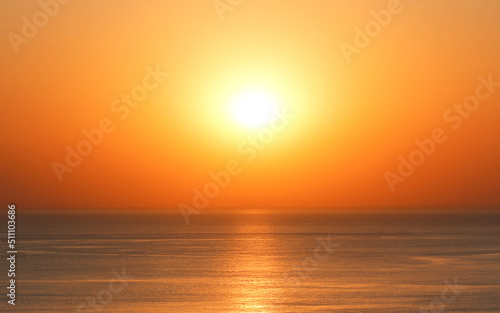 Bright sun on the horizon over the water during sunset © Надежда Д