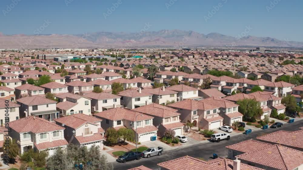 Aerial shot of pink and tan Las Vegas suburban homes with Red Rock in background Aerial shot of pink and tan Las Vegas suburban homes with Red Rock in background