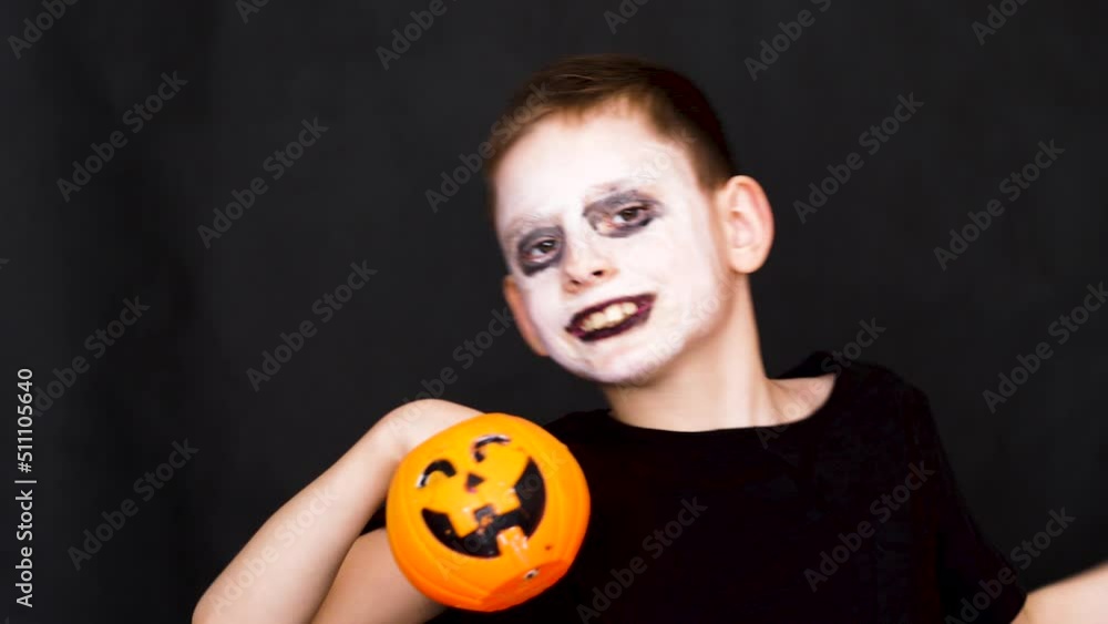 cheerful caucasian boy 8 years old in a halloween costume with monster