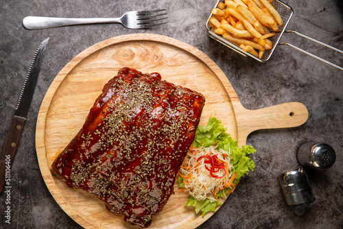 Grilled pork ribs BBQ on black plate,Top view,World food day