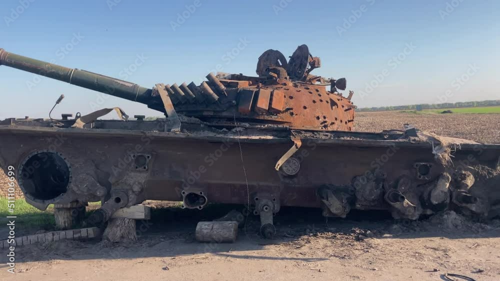 Destroyed and burned tank of the Russian army as a result of a battle with Ukrainian troops near the road near Chernihiv, Ukraine. Russian aggression in Ukraine. High quality 4k footage Destroyed and burned tank of the Russian army as a result of a battle with Ukrainian troops near the road near Chernihiv, Ukraine. Russian aggression in Ukraine. High quality 4k footage