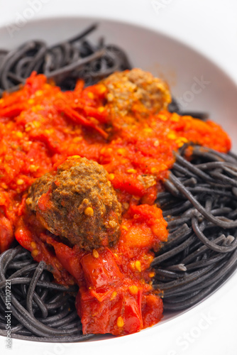 black spaghetti with tomato sauce with meat balls