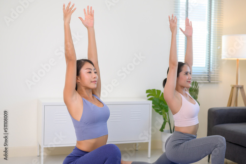 Fit young friend women doing yoga and meditation at home, sport and healthy lifestyle concept.