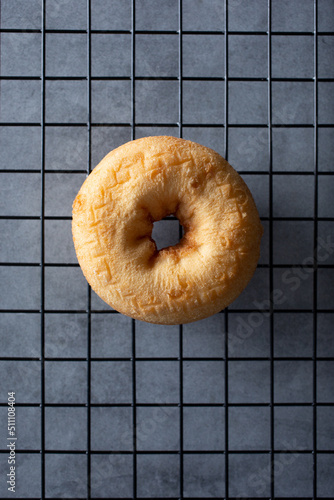 A top down view of a plain cake donut.