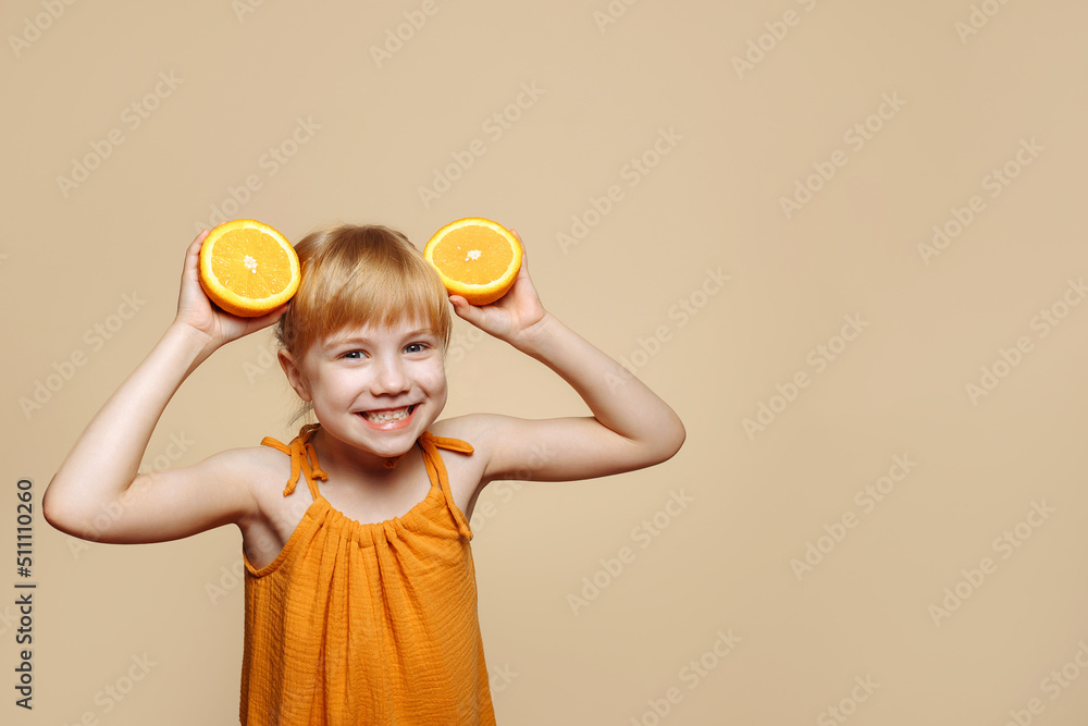 Little girl making herself ears out of oranges Little girl making herself ears out of oranges