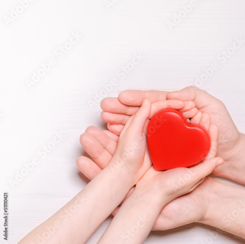 Man give red heart to kid as couple. Healthcare and hospital medical concept. Donation concept.Symbolic of Valentine day.Top view with space for text.