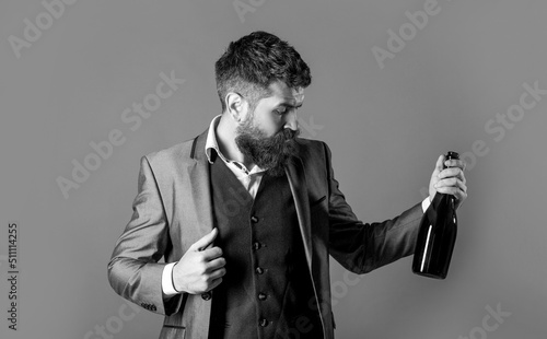 Fotografiet Bearded man with a bottle champagne of and glass