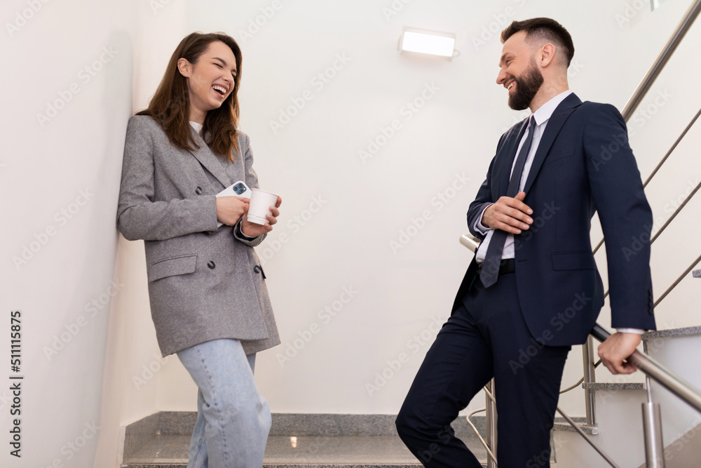 office workers chatting freely on the landing during lunch office workers chatting freely on the landing during lunch