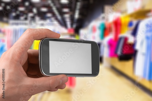 Clothing Store, Female Using Smartphone with blank screen