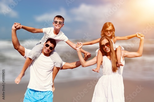 Happy family having fun on the beach. Mother and father. Summer vacation concept © BillionPhotos.com