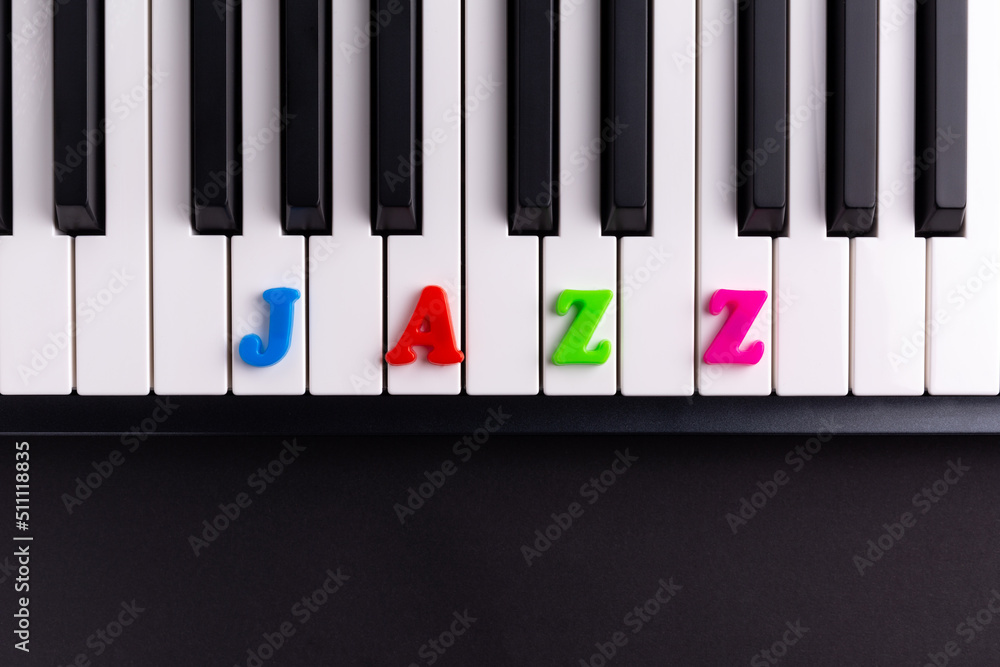 Naklejka premium The word Jazz is composed of multicolored letters on the piano keys. Copy space. 