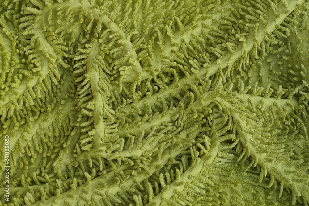 green fabric texture from a piece of crumpled carpet with long wool