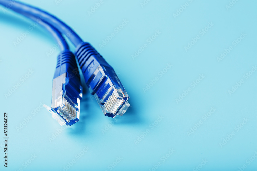Ethernet Cable connector Patch cord cord close-up on a blue background with free space Ethernet Cable connector Patch cord cord close-up on a blue background with free space