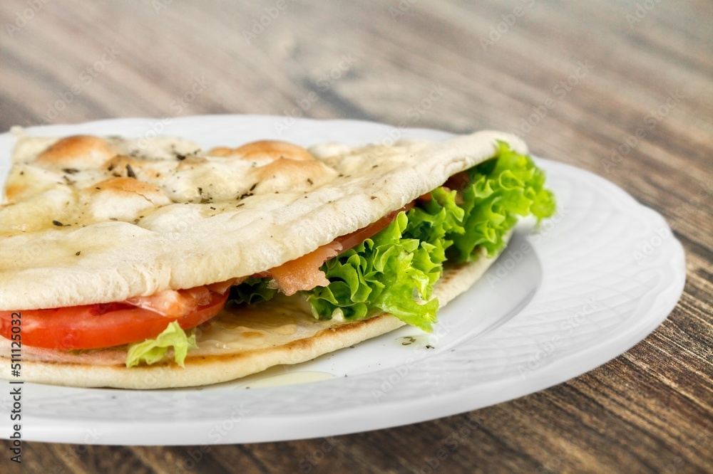 Tasty sandwich with vegetables, ham and cheese, traditional restaurant menu dish, food cooking recipe book cover. Tasty sandwich with vegetables, ham and cheese, traditional restaurant menu dish, food cooking recipe book cover.