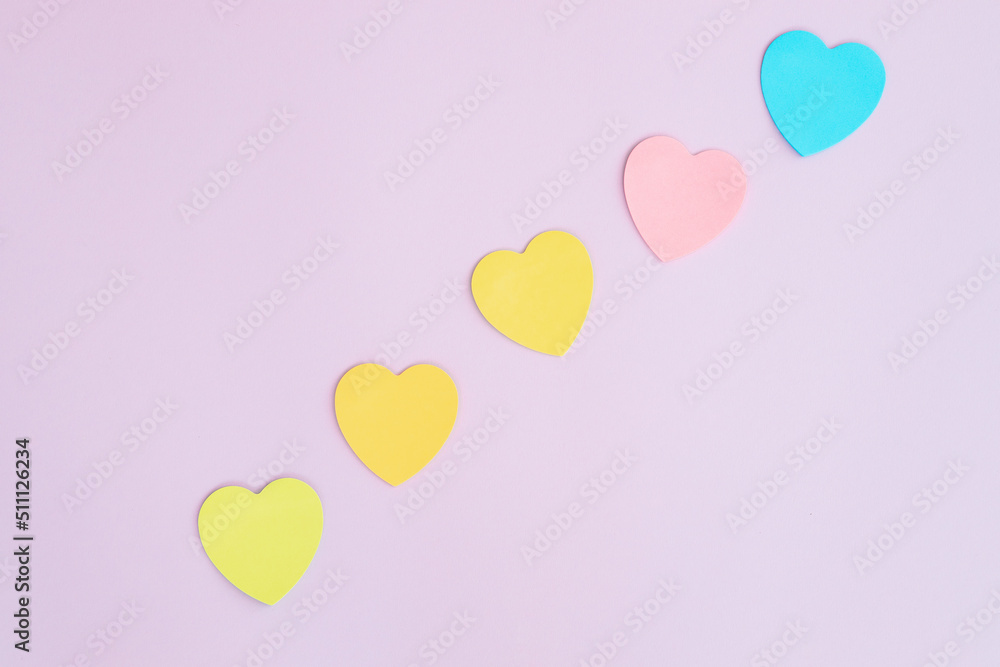 Sticky notes, heart shaped, rainbow colored line.