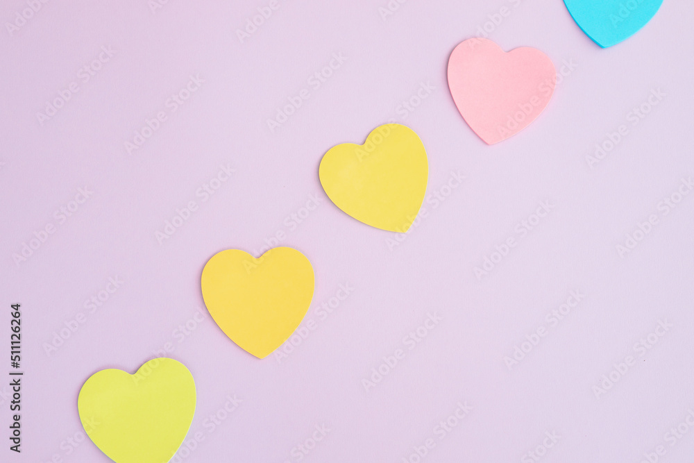 Sticky notes, heart shaped, rainbow colored line.