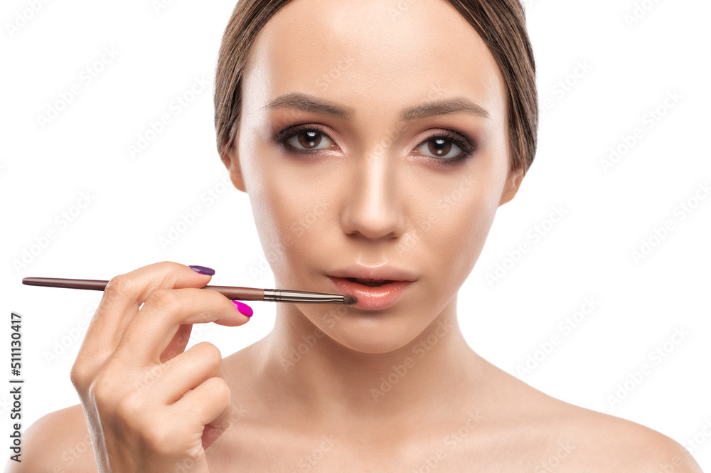 Portrait of a beautiful woman with curly hair, beautiful fresh make-up and with healthy clean skin. Make-up artist does lips make-up.Professional makeup and cosmetology skin care. Portrait of a beautiful woman with curly hair, beautiful fresh make-up and with healthy clean skin. Make-up artist does lips make-up.Professional makeup and cosmetology skin care.