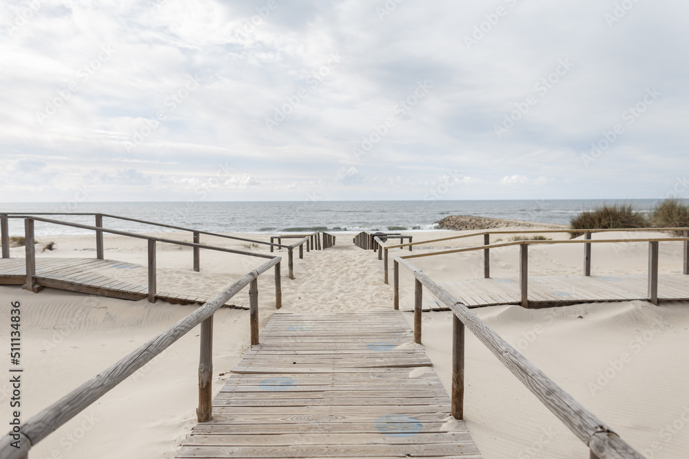 Beautiful sandy beach with wooden walkways by the ocean. Relaxing by the sea
