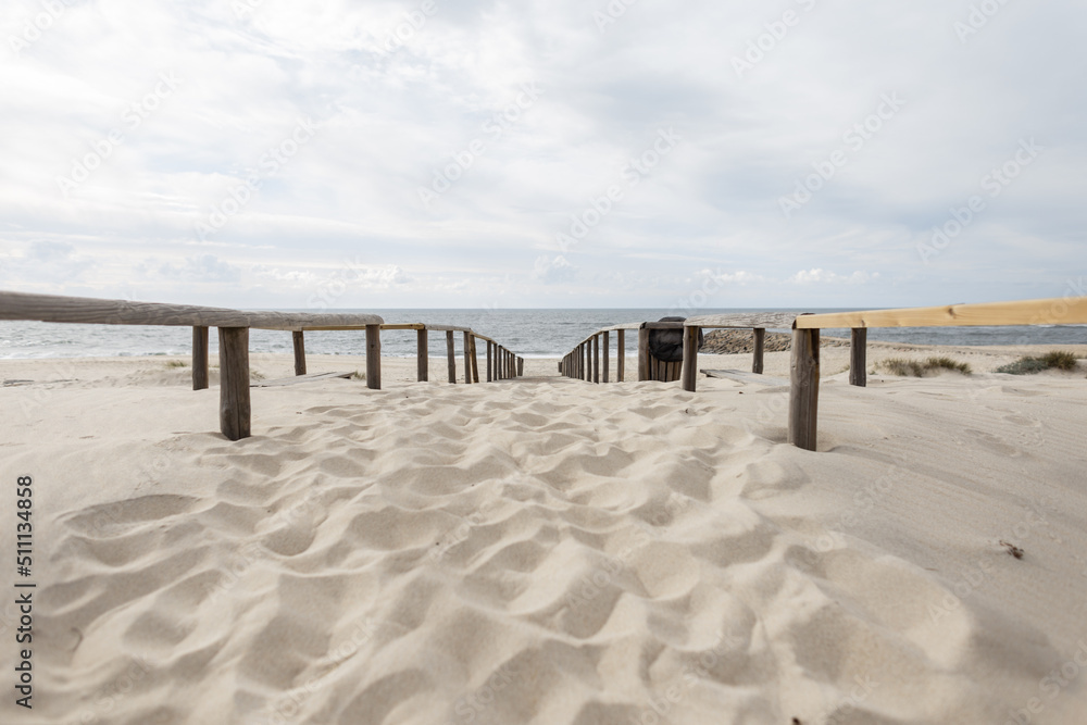 Beautiful beach with sand and wooden walkway by the ocean