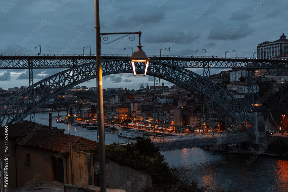 Vintage antique european night town of Porto with beautiful streets, bridge, lantern and lights