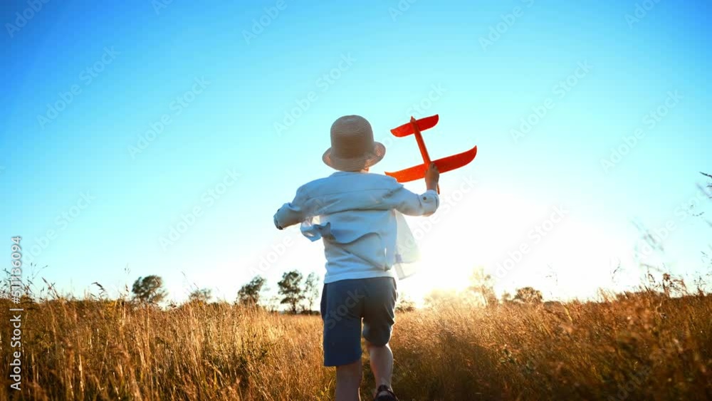 Future Pilot. Child boy runs with toy airplane on wheat field. Boy dreams of flying. Carefree boy playing outdoors. Happy kid running in nature, playing with toy airplane. Concept of child kindness.
