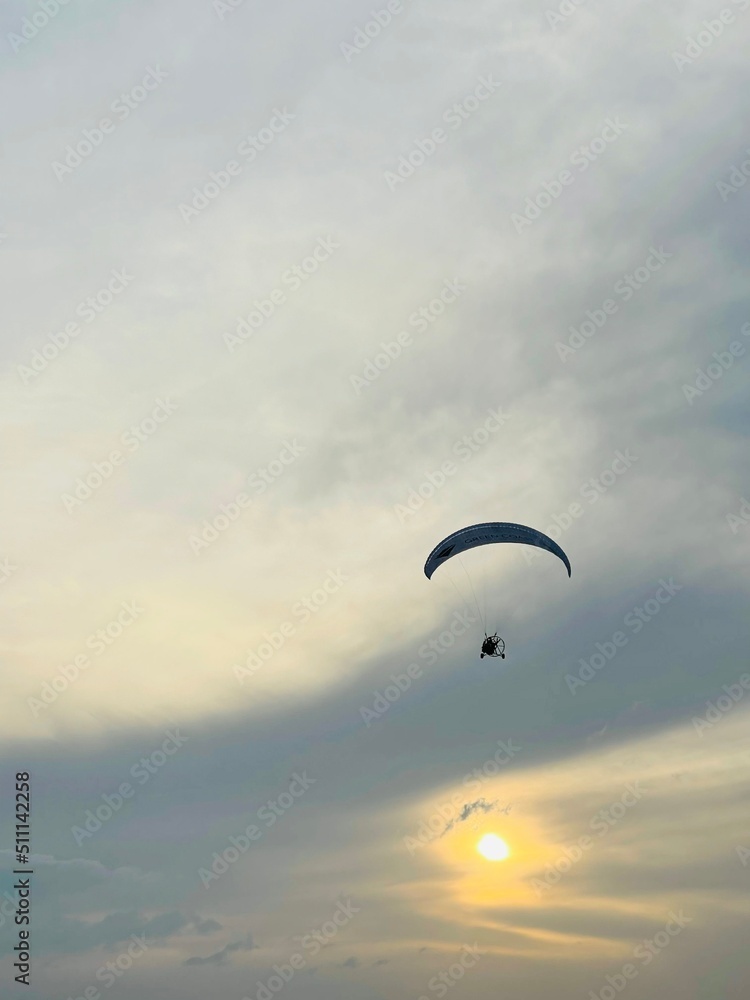Paragliding concept, paraglider pilot fly in sunset sky . Copy space Paragliding concept, paraglider pilot fly in sunset sky . Copy space