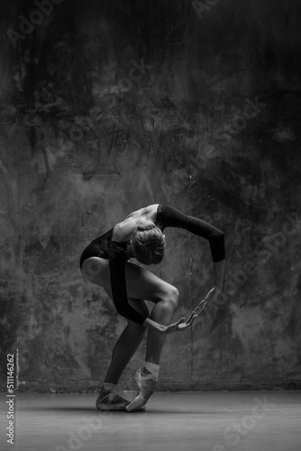 Fototapeta Young beautiful ballerina is posing in studio