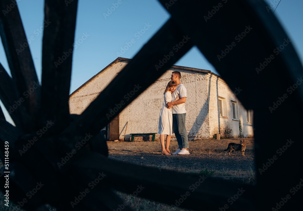 Beautiful young couple in the village at sunset Beautiful young couple in the village at sunset