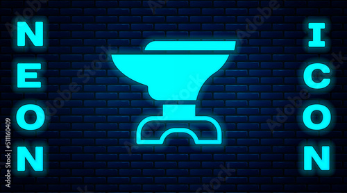 Glowing neon Anvil for blacksmithing and hammer icon isolated on brick wall background. Metal forging. Forge tool. Vector