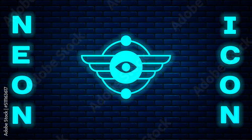 Glowing neon Egyptian symbol Winged sun icon isolated on brick wall background. Vector