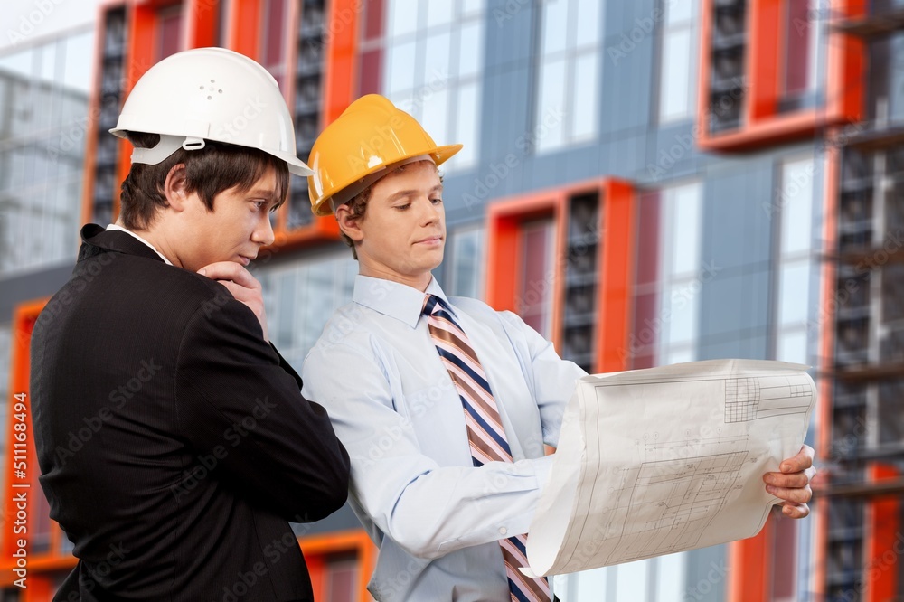 Engineer or architect with building plan at construction site, business, building, industry, people concept. Engineer or architect with building plan at construction site, business, building, industry, people concept.