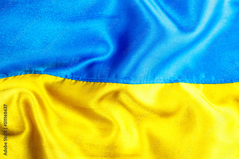 Fabric curved flag of Ukraine, UA. Blue and yellow colors.Ukrainian passport.Stop war.Patriotism.Concept of Ukraine.Democracy and politics. Close up shot, background Fabric curved flag of Ukraine, UA. Blue and yellow colors.Ukrainian passport.Stop war.Patriotism.Concept of Ukraine.Democracy and politics. Close up shot, background