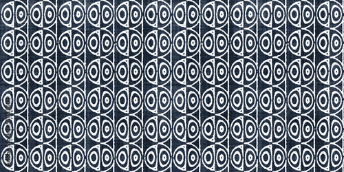 Seamless vintage mid century modern geometric optical illusion circle pattern on rough linen texture. Trendy dark indigo blue denim and white batik tribal ethnic interior and fashion surface design..