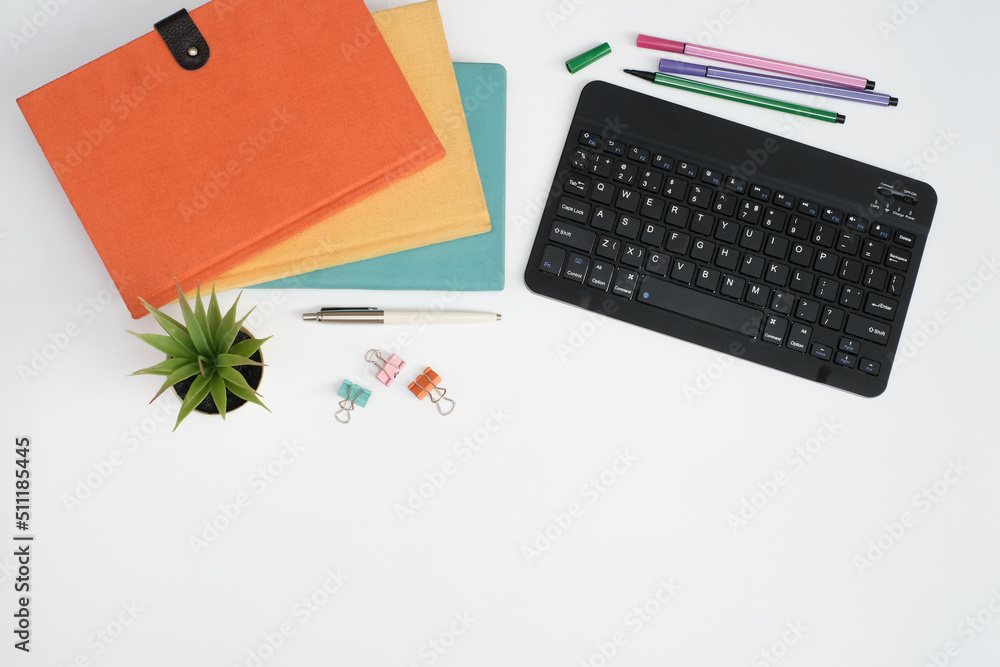 Flat lay black to school and education concept on white table desk with key board computer and stack of book , stationeries and supplies, Top view with copy space, work space Flat lay black to school and education concept on white table desk with key board computer and stack of book , stationeries and supplies, Top view with copy space, work space