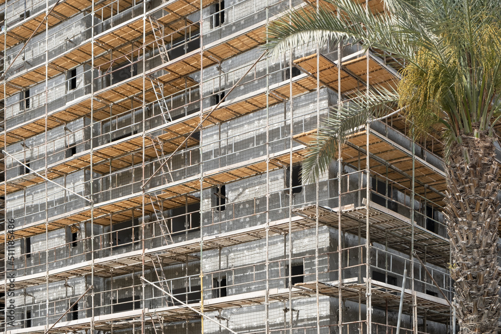 Scaffolding on the construction site in Israel. Modern Apartments Architecture Building infrastructure concept.