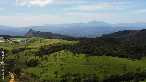 Aerial view of Pastures with green grass among the hills in a mountainous province. Ambewela, Nuwara Eliya, Sri Lanka. photo