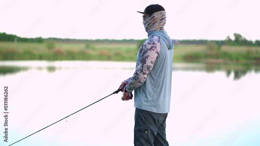 The fisherman sportsman catches a predatory fish on a spinning on the lake The fisherman sportsman catches a predatory fish on a spinning on the lake