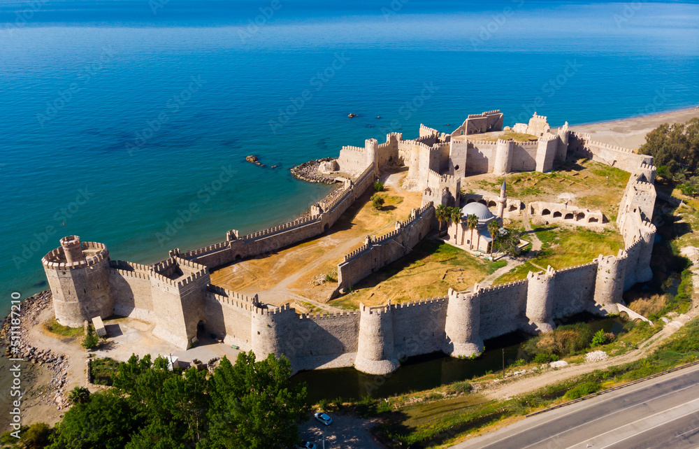 Scenic aerial view of ancient well-preserved fortified Mamure Castle in spring day on shore of Mediterranean Sea near Anamur town in Mersin Province, Turkey