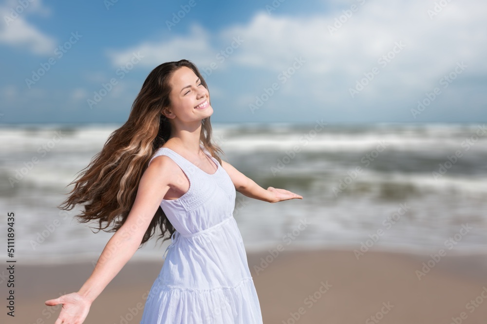 Healthy woman standing on the beach. Freedom girl dancing and daydreaming at beach during summer vacation. Healthy woman standing on the beach. Freedom girl dancing and daydreaming at beach during summer vacation.