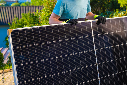 Solar energy.Green energy. Solar panel in the hands of a worker in a summer garden. Fitting and installation of solar panels.renewable energy.alternative energy from nature.solar power technology. 