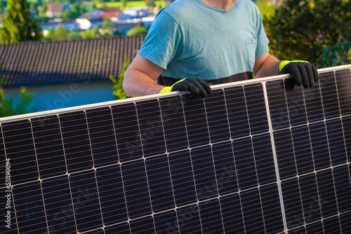 Solar panel in the hands of a worker in a summer garden. Fitting and installation of solar panels.renewable energy.alternative energy from nature.solar power technology. Green energy. 