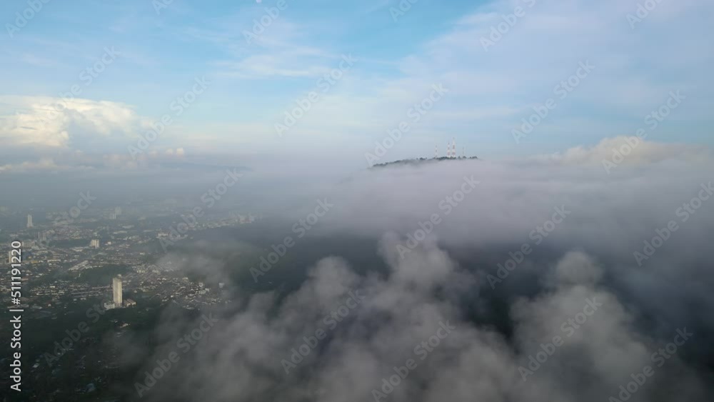 Aerial view move over foggy cloud at forest beside the residential town Aerial view move over foggy cloud at forest beside the residential town