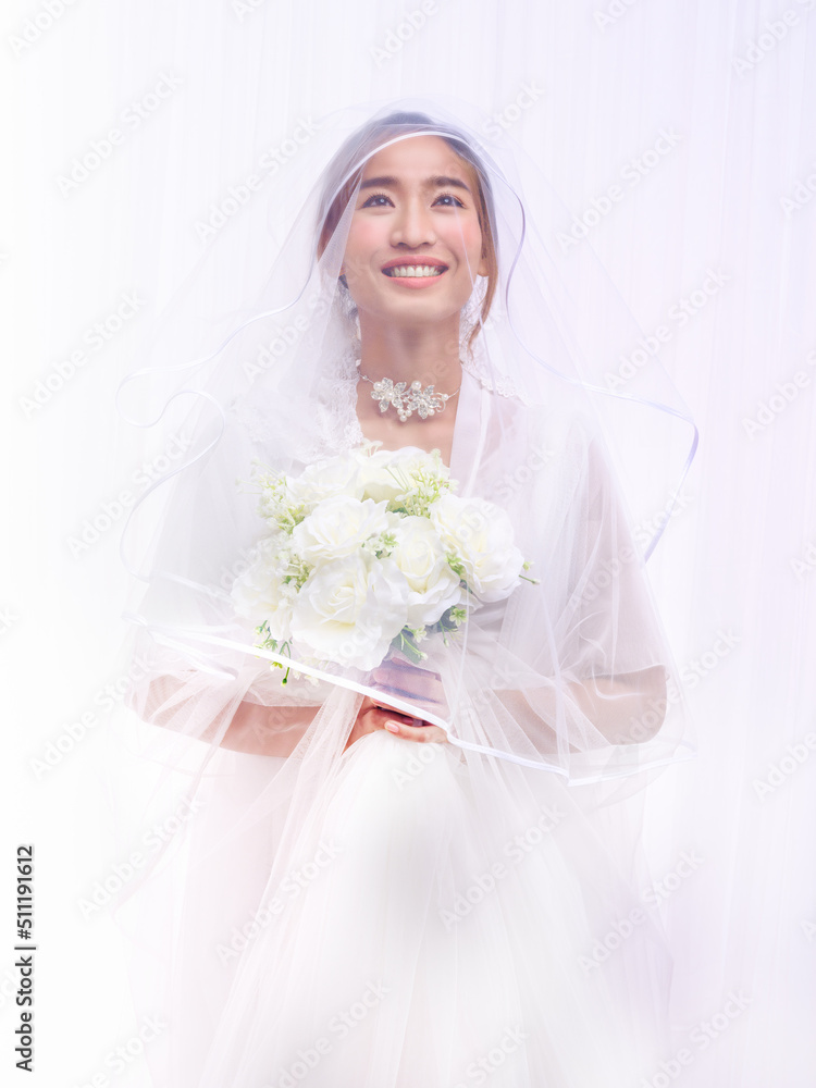 bride in white gown with veil holding flower bouquet bride in white gown with veil holding flower bouquet