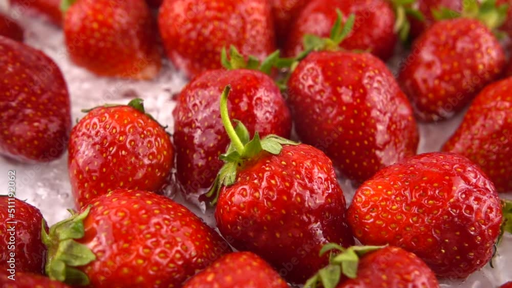 Splashes of water fall on strawberries. Slow motion. Splashes of water fall on strawberries. Slow motion.