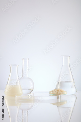 Front view of scientist working with chemical reaction in chemistry laboratory rice in transparent test tube and pink blackground with blank space for advertising 