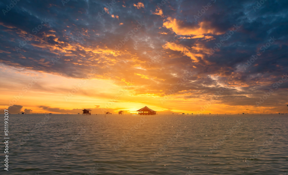 sunset over a fisherman village in the sea, Thailand. Travel and Hideaway concept.