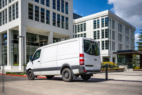 Compact cargo mini van delivered goods to multilevel urban apartments city neighborhood © vit