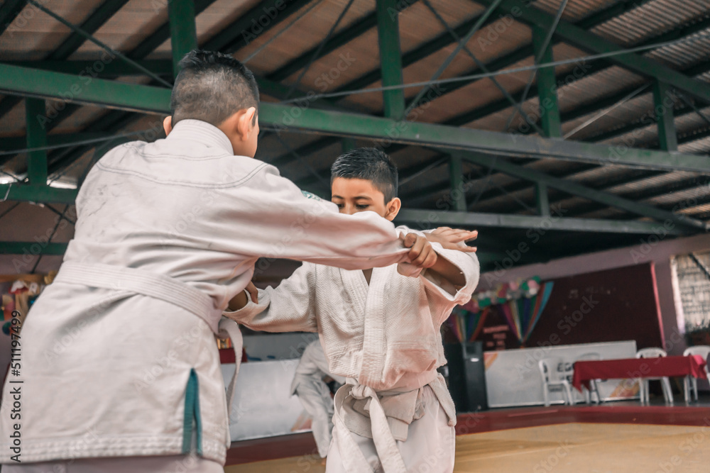 Two Latino boys practicing judo in a gym in Managua Nicaragua
